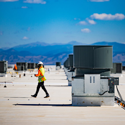 Construction worker walking on a rooftop