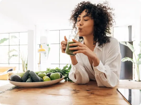 Woman enjoying a freshly made vegetable smoothie