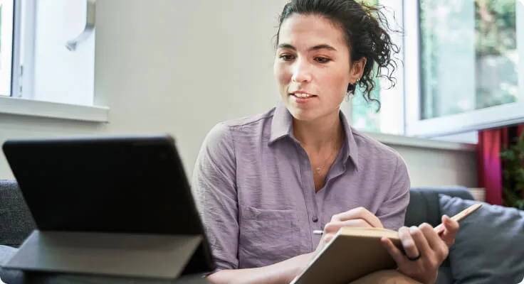 Woman with notebooks comfortable in her living room.