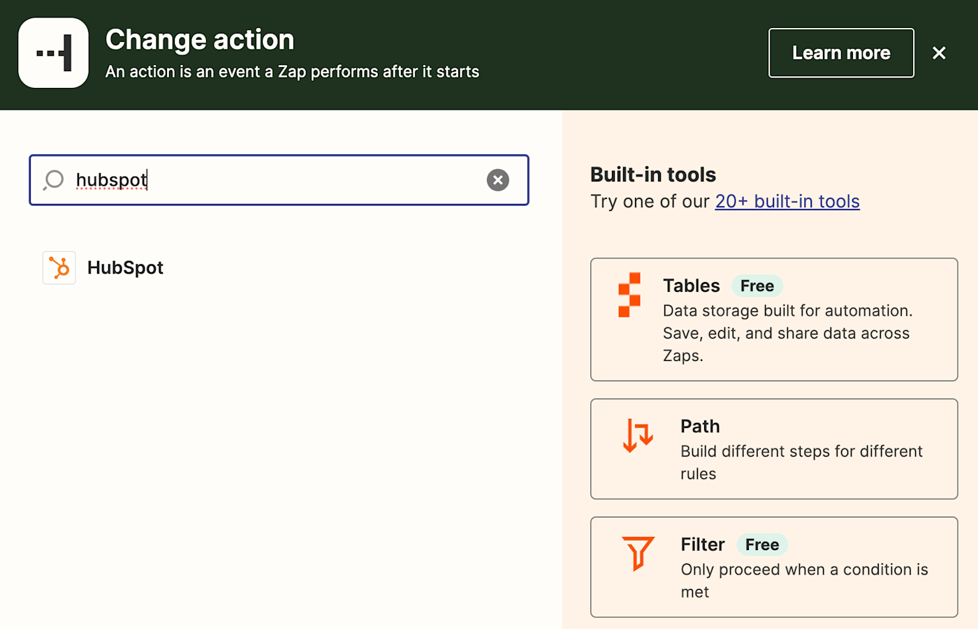 An action step in the Zap editor with HubSpot added to the action app search field.