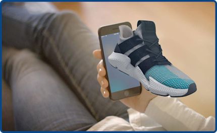 An AR example where a sneaker appears to emerge from a smartphone screen.