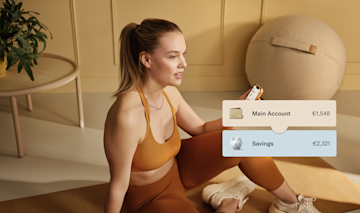 Image of a woman in sportswear sitting on a yoga mat.