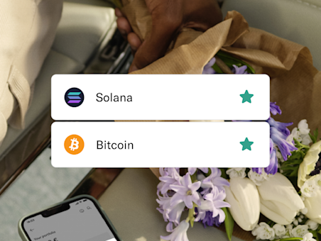 Tether and Bitcoin crypto coins and some flowers in the background.